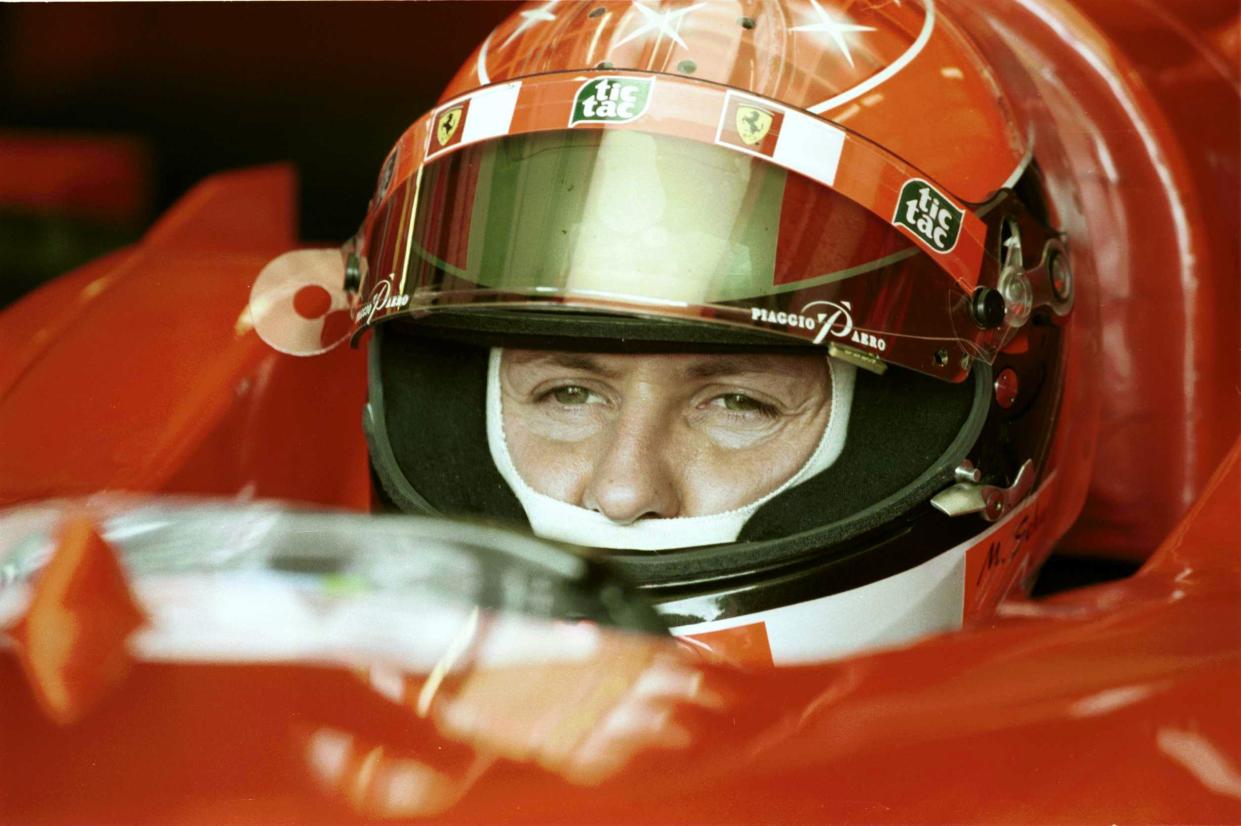 Ferrari's Michael Schumacher studies the technical information on the overhead moniters before today's practice at the British Grand Prix  (Photo by Steve Mitchell/EMPICS via Getty Images)