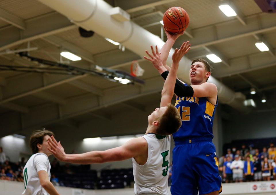 Bolivar sophomore Kyle Pock shoots a field goal over Springfield Catholic's Zachary Howell during the class 5 district 10 championship game at Southwest Baptist University in Bolivar on Thursday, March 4, 2021.