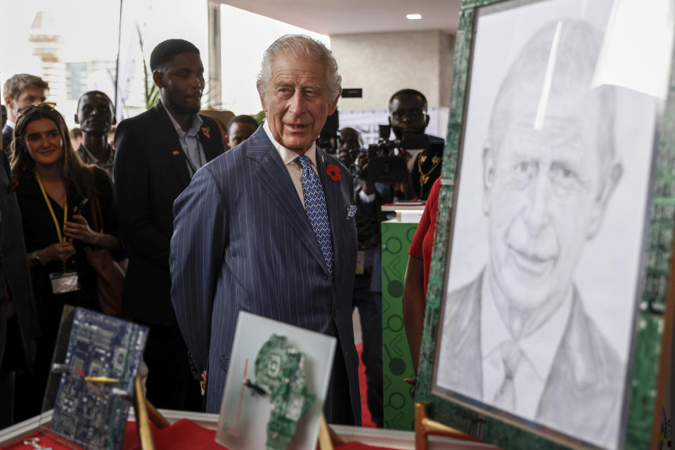 Britain's King Charles III walks past his portrait during a visit to a Tech and Innovation showcase at Nairobi Garage in Nairobi, Kenya, Tuesday. Oct. 31, 2023. King Charles is in Kenya for a four-day trip, his first state visit to a Commonwealth country as monarch, underscoring his commitment to an organization that's been central to Britain's global power and prestige since World War II. (Luis Tato, Pool via AP)