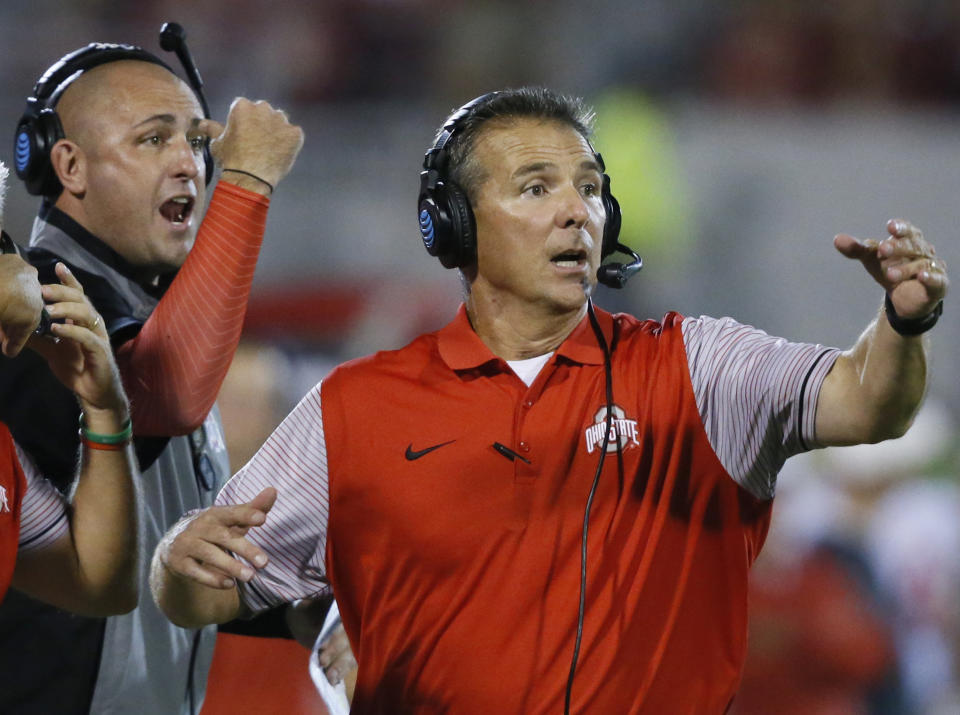 Ohio State’s Urban Meyer, right, and then-assistant coach Zach Smith, left, gesture from the sidelines during a game. (AP)