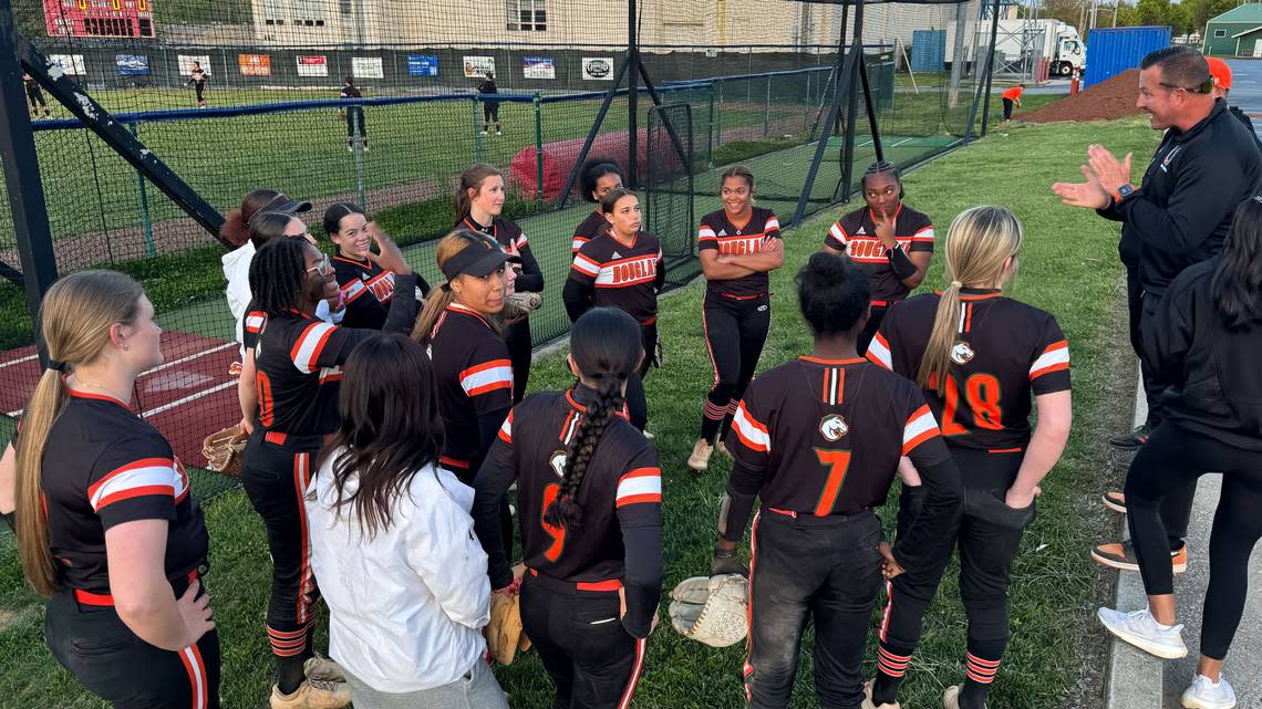 Frederick Douglass softball coach Jason McGuire, right, praised his team after the Broncos’ 13-7 win at Lafayette High School on Monday. Jared Peck/jpeck@herald-leader.com