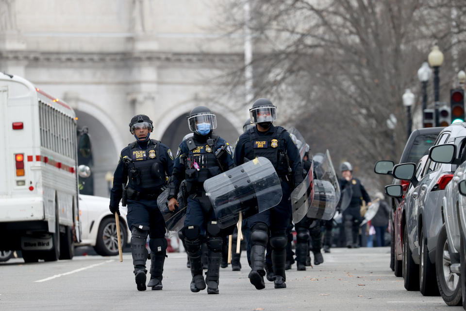 WASHINGTON, DC - JANUARY 06: Police officers in riot gear walks towards the U.S. Capitol as protesters enter the building on January 06, 2021 in Washington, DC. Trump supporters gathered in the nation's capital today to protest the ratification of President-elect Joe Biden's Electoral College victory over President Trump in the 2020 election. (Photo by Tasos Katopodis/Getty Images)