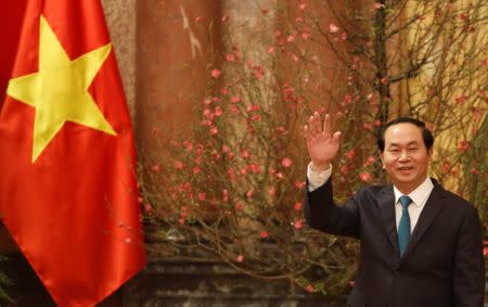 FILE PHOTO: Vietnam's President Tran Dai Quang waves his hand to the media as he waits for arrival of Japan's Prime Minister Shinzo Abe at the Presidential Palace in Hanoi, Vietnam January 16, 2017. REUTERS/Kham