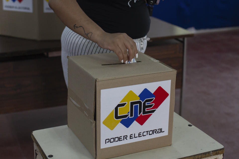 A woman casts her ballot during a rehearsal for the July 28 presidential election, in Caracas, Venezuela, Sunday, June 30, 2024. (AP Photo/Cristian Hernandez Fortune)