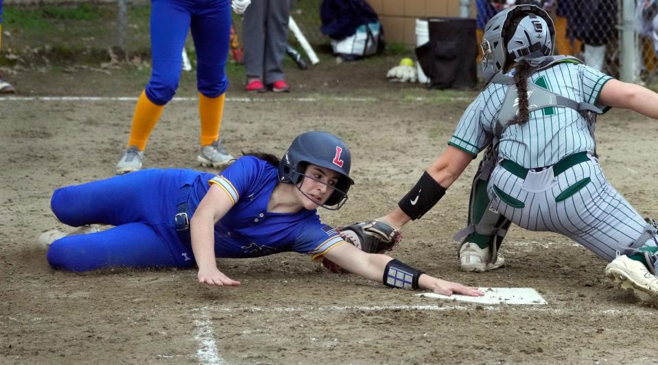 North Providence/LincolnCo-op runner Lauren Cipriano makes a sliding attempt to score but is called out at home by Ponaganset catcher Kyla Angell in the top of the fifth inning.