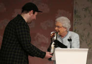 Britain's Queen Elizabeth II presents the inaugural Queen Elizabeth II Award for British Design to Richard Quinn after his show at London Fashion Week, in London, Britain February 20, 2018. REUTERS/Paul Hackett