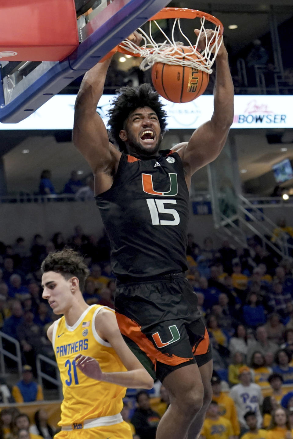 Miami forward Norchad Omier (15) dunks the ball in front of Pittsburgh forward Jorge Diaz Graham (31) during the first half of an NCAA college basketball game in Pittsburgh, Saturday, Jan. 28, 2023. (AP Photo/Matt Freed)