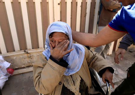 An Iraqi woman, who was left behind by her family, reacts while hearing shooting from helicopter, as Iraqi forces battle with Islamic State militants, in western Mosul, Iraq March 9, 2017. REUTERS/Zohra Bensemra