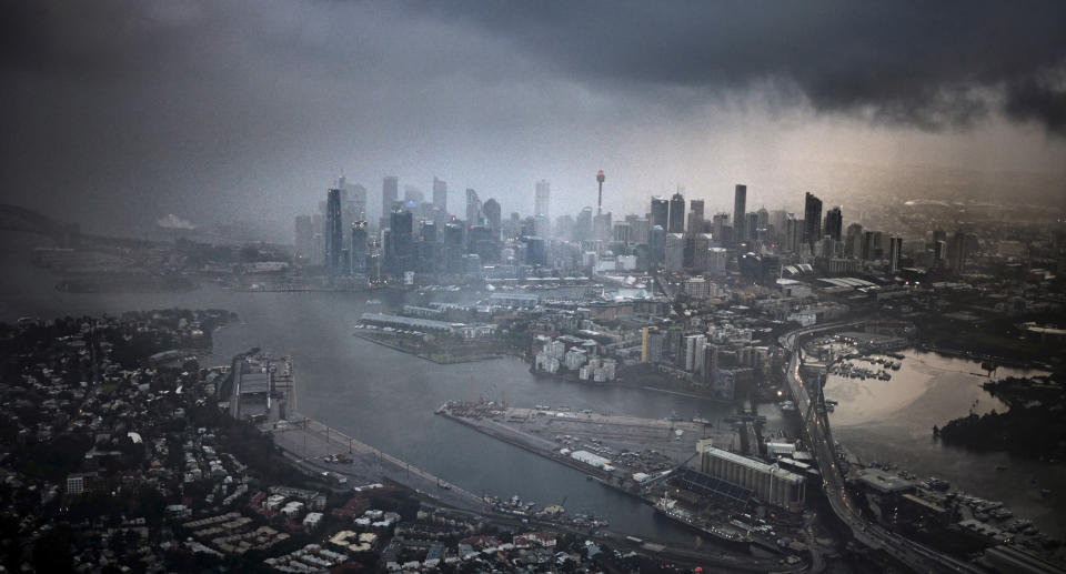 A storm over an aerial view of Sydney city.