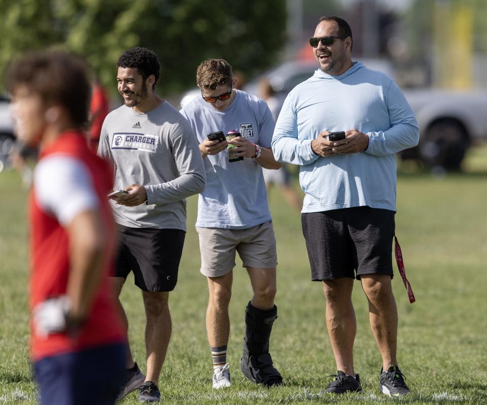 Mike Wilson talks with coaches and parents while watching his son Isaac Wilson during a 7-on-7 passing league game in Layton on Friday, June 9, 2023. | Scott G Winterton, Deseret News