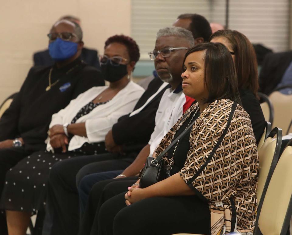 Community leaders, including Akron City Council President Margo Sommerville, right, listen to Akron Mayor Dan Horrigan during the press conference Sunday at the Firestone Park Community Center.