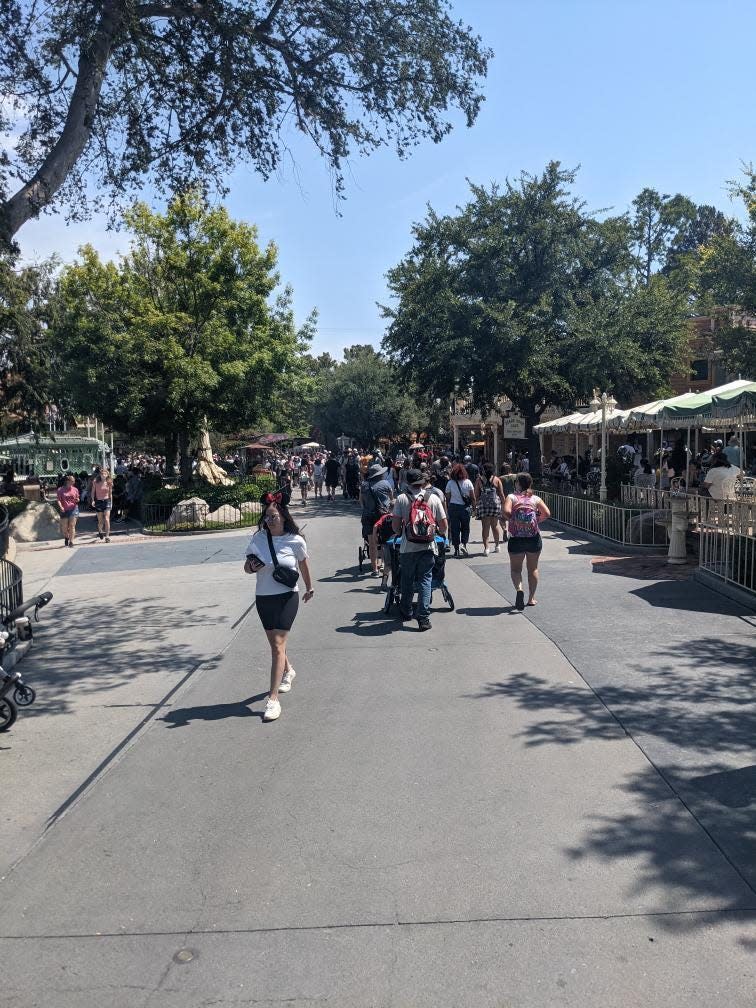 People walk around Disneyland without masks on June 15, 2021.