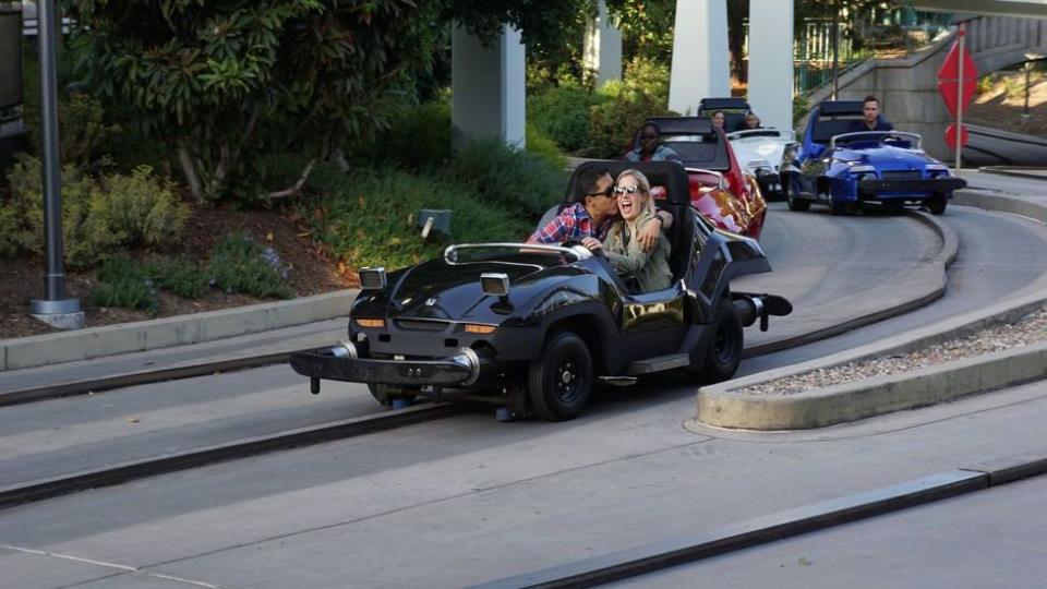 a person driving a convertible car