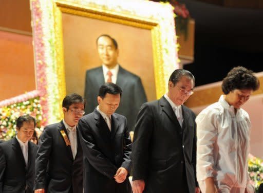 Unification Church devotees stand in front of a portrait of the late Sun Myung Moon as they mourn his death at the church headquarters in Gapyeong. The atmosphere was sombre but calm, as Hyung-Jin Moon, Moon's youngest son and successor, received the mourners