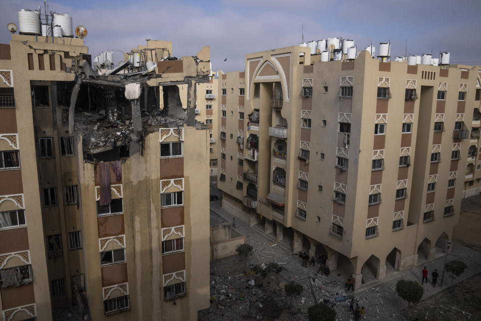 Palestinians inspect the rubble of the home of Ali Ghali, a senior Islamic Jihad commander, after it was struck by an Israeli airstrike in Khan Younis, southern Gaza Strip, Thursday, May 11, 2023. Early on Thursday, the Israeli military killed Ghali, said to be in charge of the group's rocket force, when it struck his home as part of strikes against the Islamic Jihad militant group. (AP Photo/Fatima Shbair)