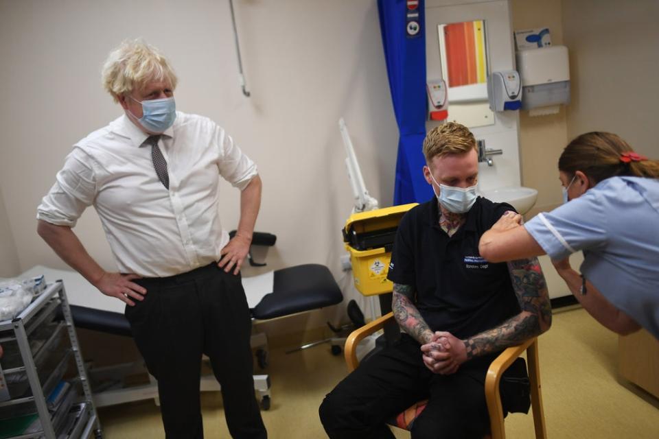 Prime Minister Boris Johnson watches as nurse Sandra Guy gives a Covid-19 booster jab during a visit to Hexham General Hospital in Northumberland (Peter Summers/PA) (PA Wire)