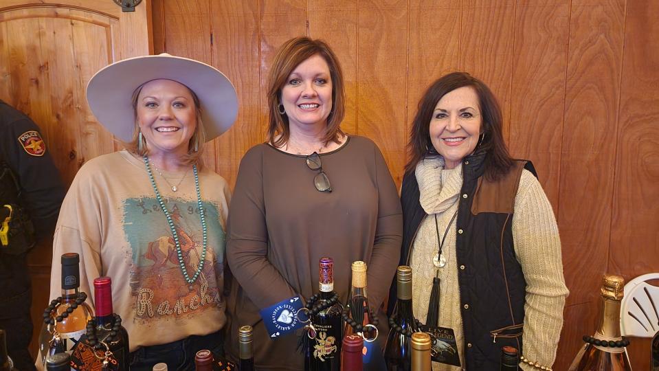 Members of the 10 Club greet attendees Saturday at the 100 Club of the Texas Panhandle's annual Bandfest in Bushland.