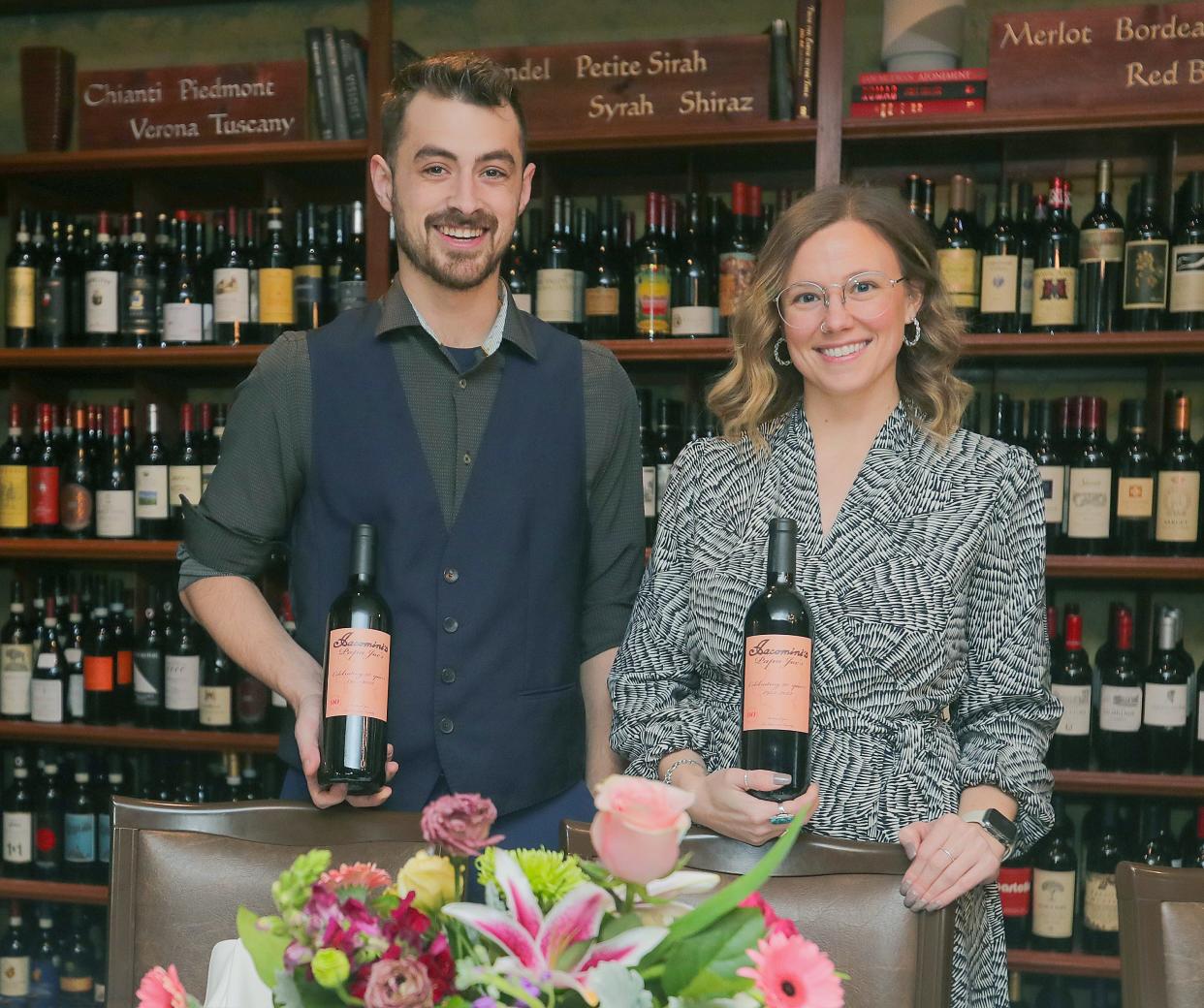 Papa Joe’s wine manager Daniel Amato and general manager Morgan Massey with a bottle of Iacomini’s 90th anniversary cabernet on Friday in Akron.