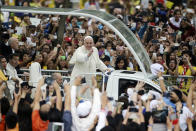 FILE - In this Jan. 18, 2015, file photo, crowds cheer as Pope Francis passes by during his meeting with the youth at the University of Santo Tomas in Manila, Philippines. Across the globe, Pope Francis’ comments endorsing same-sex civil unions were received by some as encouragement for an advancing struggle and condemned by others as an earth-shaking departure from church doctrine. (AP Photo/Aaron Favila, File)