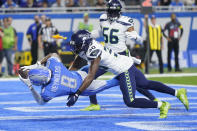 Detroit Lions wide receiver Josh Reynolds (8), defended by Seattle Seahawks cornerback Mike Jackson (30), catches a 3-yard pass for a touchdown during the second half of an NFL football game, Sunday, Oct. 2, 2022, in Detroit. (AP Photo/Paul Sancya)