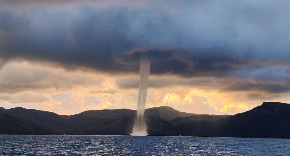 A waterspout, a huge column of water and air, appears in the ocean near Hayman Island.