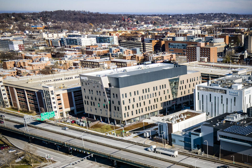 File - This photo shows Upstate University Hospital campus highlighting the Nappi Wellness Institute, center, near Interstate 81 in Syracuse, N.Y., Jan. 16, 2023. New York's hospitals and healthcare providers are now banned from reporting medical debt to credit agencies, after Gov. Kathy Hochul signed into law a series of consumer protection bills on Wednesday, Dec. 13. (AP Photo/Ted Shaffrey, File)