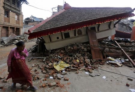 An earthquake victim walks past a collapsed temple in Sankhu, on the outskirts of Kathmandu, May 2, 2015. REUTERS/Adnan Abidi