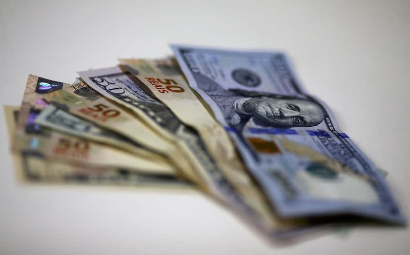 FILE PHOTO: Brazilian Real and U.S. dollar notes are pictured at a currency exchange office in Rio de Janeiro