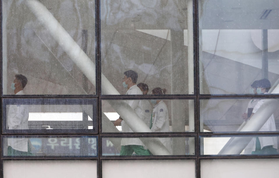 Doctors walk inside a general hospital in Seoul, South Korea, Wednesday, Feb. 21, 2024. South Korea on Wednesday officially ordered thousands of striking doctors to return to work immediately, a step that could lead to legal punishments if the doctors don't end their walkouts, which have caused numerous cancellations of surgeries and other treatments at hospitals. (Kim Ju-sung/Yonhap via AP)