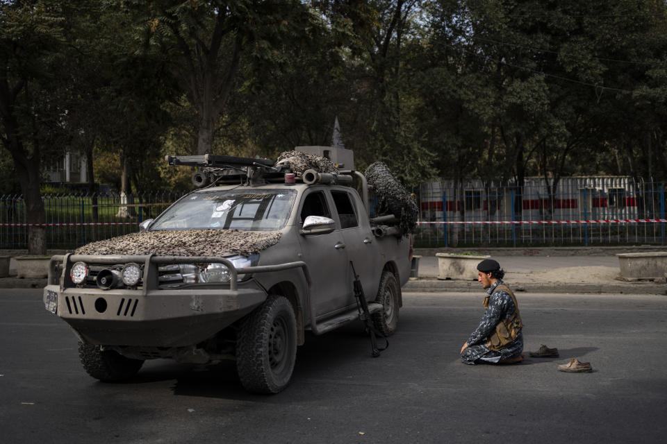 A Taliban fighter prays next a demonstration organized by the Afghan Society of Muslim Youth, demanding the release of frozen international money in Kabul, Afghanistan, Friday, Sept. 24, 2021. (AP Photo/Bernat Armangue)