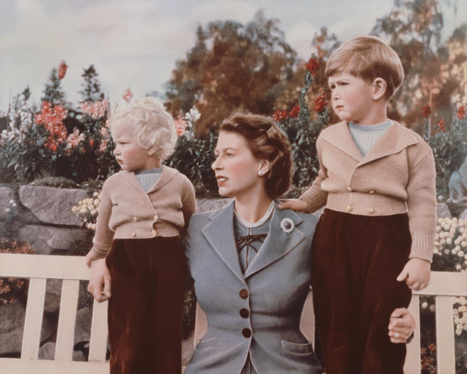 Princess Anne with her brother Prince Charles and their mother the Queen in the grounds of Balmoral Castle, Scotland in 1952. (Getty Images)