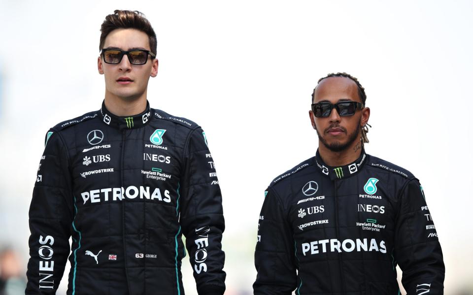 George Russell of Great Britain and Mercedes and Lewis Hamilton of Great Britain and Mercedes walk in the Paddock during Day One of F1 Testing at Bahrain International Circuit on March 10, 2022 in Bahrain, Bahrai - Getty Images