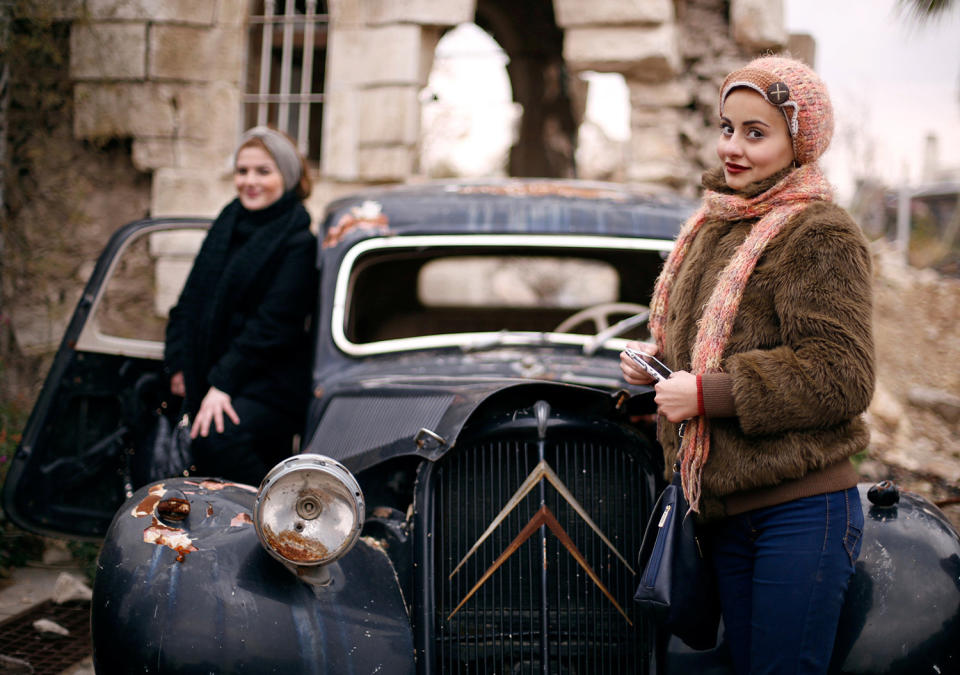 Women pose for a picture at the entrance of the Carlton Hotel