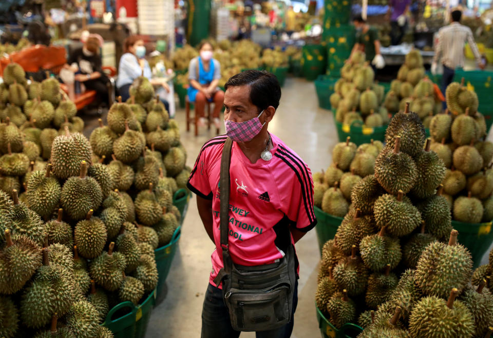 A man wearing a protective face mask works in a durian shop during the coronavirus disease (COVID-19) outbreak, at Talad Thai wholesale market outside Bangkok, Thailand April 20, 2020. REUTERS/Soe Zeya Tun