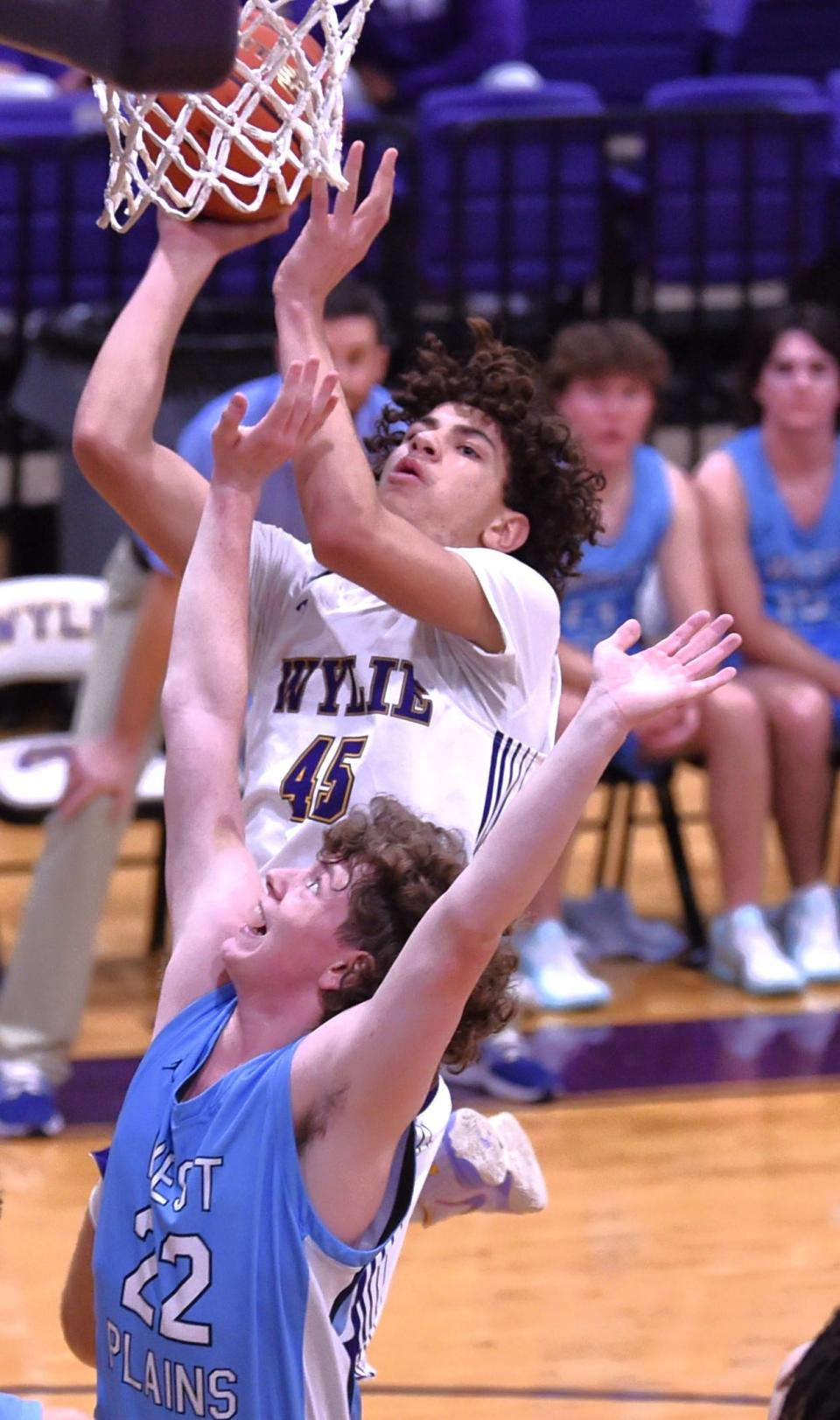 Wylie's Will Evans (45) shoots over West Plains' Cade Bullard in the first half. The Wolves beat Wylie 57-53 on the opening day of the Wylie Lions Club's Catclaw Classic on Thursday at Bulldog Gym.