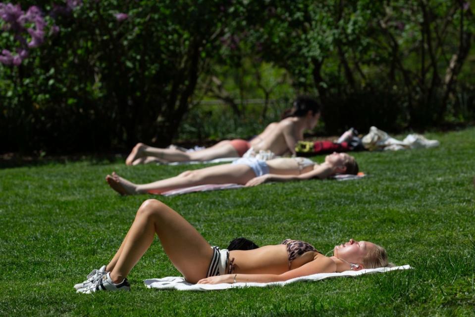 Heat-deprived locals were spotted sunning themselves in Central Park on Monday. James Messerschmidt