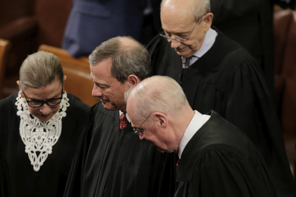 FILE - In this Jan. 12, 2016, file photo, Supreme Court Justices, from left, Ruth Bader Ginsburg, Chief Justice John Roberts, Anthony Kennedy and Stephen Breyer arrive on Capitol Hill in Washington, for President Barack Obama's State of the Union address before a joint session of Congress. Ginsburg didn’t put on her judge’s robe without also fastening something around her neck. Ginsburg called her neckwear collars, or jabots, and they became part of her signature style, along with her glasses, lace gloves and fabric hair ties known as scrunchies. (AP Photo/J. Scott Applewhite, File)