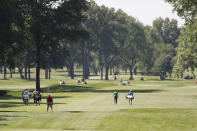 Golfers walk on the sixth fairway during the second round of the Rocket Mortgage Classic golf tournament, Friday, July 3, 2020, at the Detroit Golf Club in Detroit. (AP Photo/Carlos Osorio)