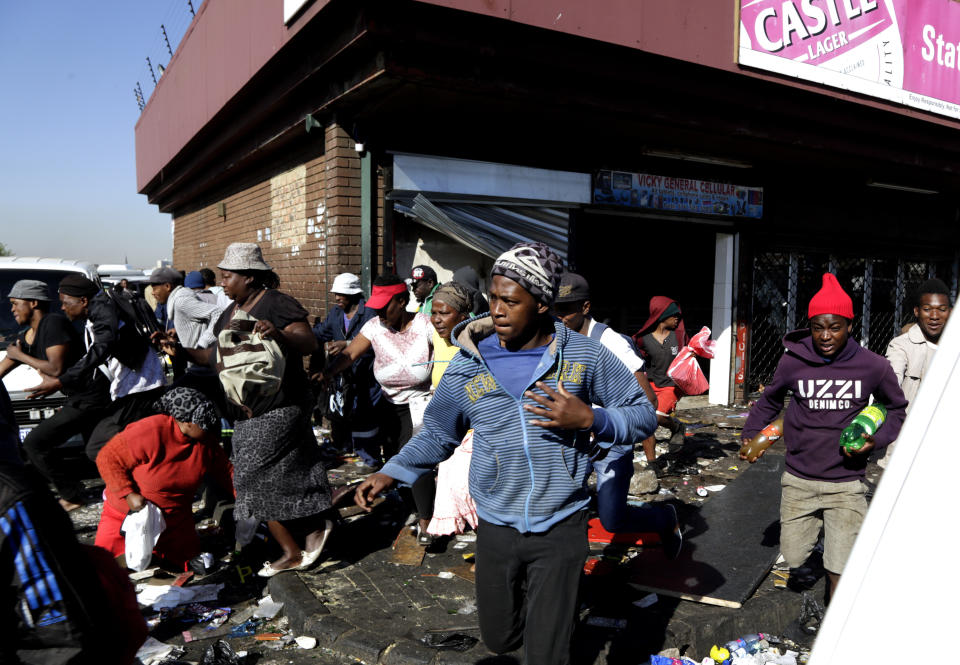 Looters make off with goods from a store in Germiston, east of Johannesburg, South Africa, Tuesday, Sept. 3, 2019. Police had earlier fired rubber bullets as they struggled to stop looters who targeted businesses as unrest broke out in several spots in and around the city. (AP Photo/Themba Hadebe)