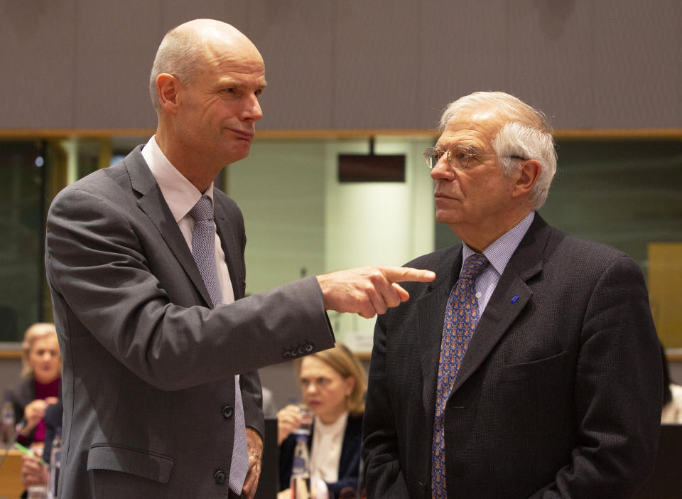 Dutch Foreign Minister Stef Blok, left, speaks with European Union foreign policy chief Josep Borrell during a meeting of EU foreign ministers at the Europa building in Brussels, Monday, Dec. 9, 2019. European Union foreign ministers are debating how to respond to a controversial deal between Turkey and Libya that could give Ankara access to a contested economic zone across the Mediterranean Sea. (AP Photo/Virginia Mayo)