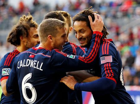 Nov 23, 2014; Harrison, NJ, USA; New England Revolution midfielder Jermaine Jones (13) (right) is congratulated by midfielder Scott Caldwell (6) after scoring the game-winning goal in the 85th minute against the New York Red Bulls during the Eastern Conference Championship at Red Bull Arena. The Revolution defeated the Red Bulls 2-1. Mandatory Credit: Andy Marlin-USA TODAY Sports