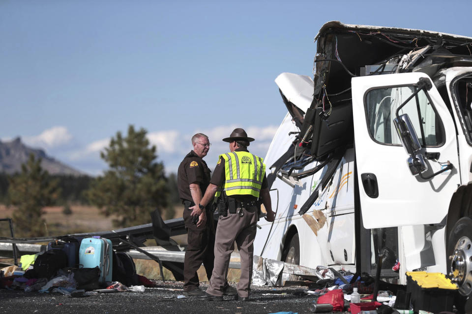 Two Utah Highway patrolmen continue to work the scene where at least four people were killed in a tour bus crash near Bryce Canyon National Park, Friday, Sept. 20, 2019, in Utah. (Spenser Heaps/The Deseret News via AP)