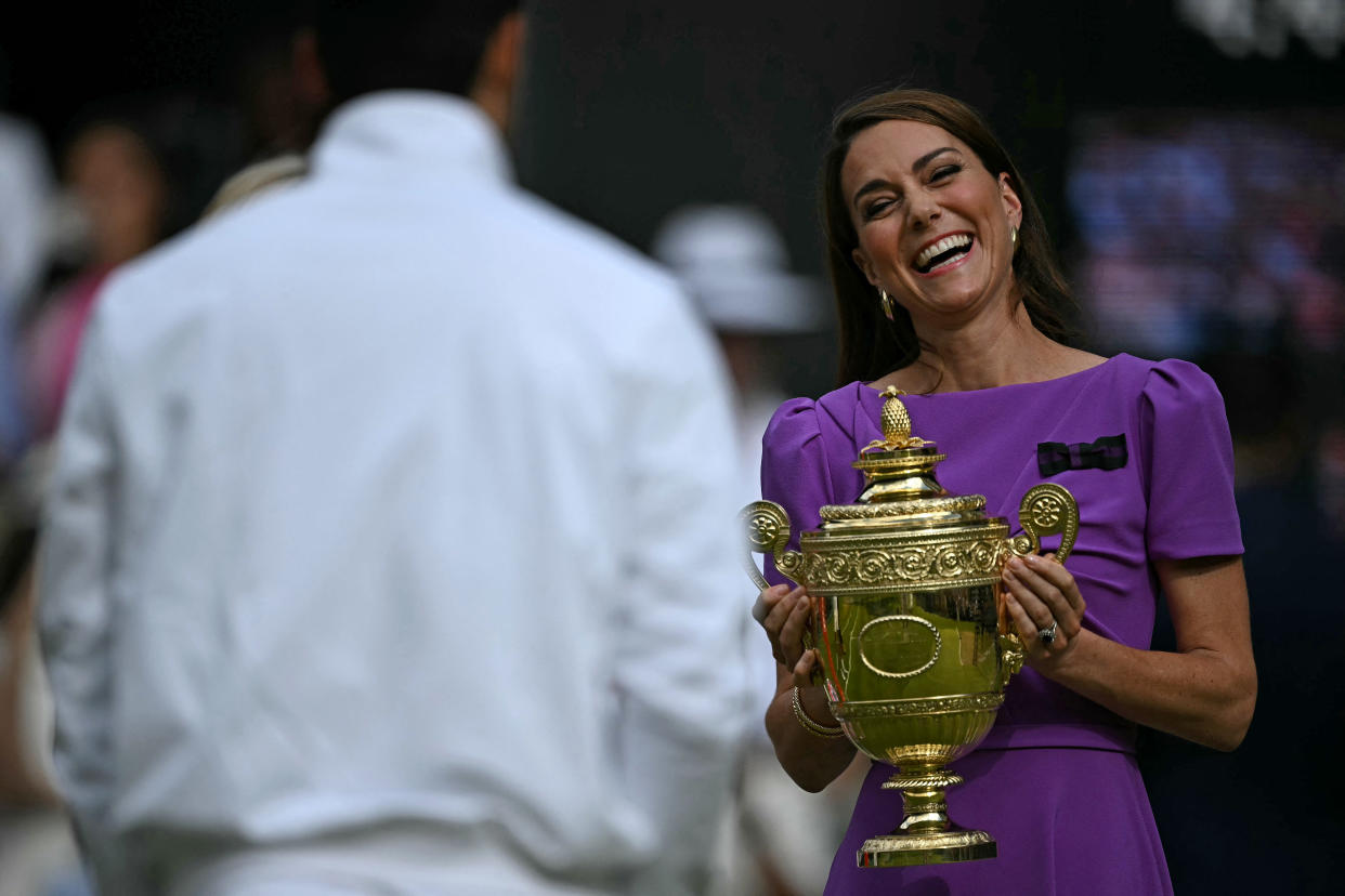 TOPSHOT - Britain's Catherine, Princess of Wales prepares to give the winner's trophy to Spain's Carlos Alcaraz following his victory against Serbia's Novak Djokovic during their men's singles final tennis match on the fourteenth day of the 2024 Wimbledon Championships at The All England Lawn Tennis and Croquet Club in Wimbledon, southwest London, on July 14, 2024. Defending champion Alcaraz beat seven-time winner Novak Djokovic in a blockbuster final, with Alcaraz winning 6-2, 6-2, 7-6. (Photo by Ben Stansall / AFP) / RESTRICTED TO EDITORIAL USE (Photo by BEN STANSALL/AFP via Getty Images)