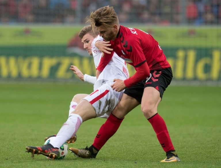 Leipzig's forward Timo Werner (L) and Freiburg's forward Lucas Hoeler fight for the ball during on January 20, 2018