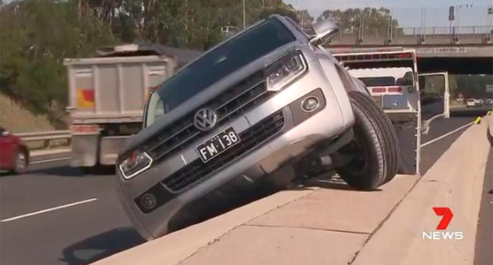 The ute driver allegedly tried to cross back over the median strip at Padstow, but ended up crashing into the centre barrier, leaving two wheels in the air. Source: 7 News