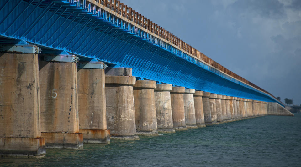 This Monday, Jan. 10, 2022, photo provided by the Florida Keys News Bureau shows the restored Old Seven Mile Bridge ready for its Wednesday, Jan. 12, 2022, reopening to pedestrians, bicyclists, anglers and visitors to Pigeon Key. The old bridge originally was part of Henry Flagler's Florida Keys Over-Sea Railroad that was completed in 1912. The railroad ceased operations in 1935 and was converted into a highway that opened in 1938. In 1982, construction was completed on a new Seven Mile Bridge that continues to carry motor vehicles between the South Florida mainland throughout the Keys to Key West. (Andy Newman/Florida Keys News Bureau via AP)