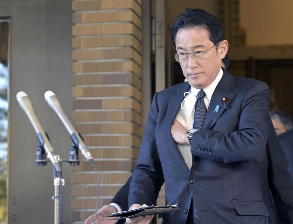 Japanese Prime Minister Fumio Kishida prepares to speak before reporters in Tokyo, Wednesday, Feb. 23, 2022. Kishida has announced sanctions targeting Russia and two separatist Ukrainian regions recognized as independent by Russian President Vladimir Putin, joining an international effort seeking to pressure Russia to return to diplomatic solutions. (Kyodo News via AP)