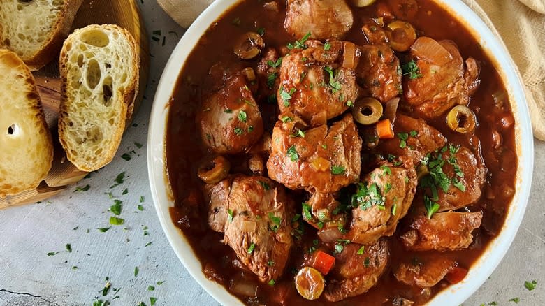 chicken cacciatore dish with bread