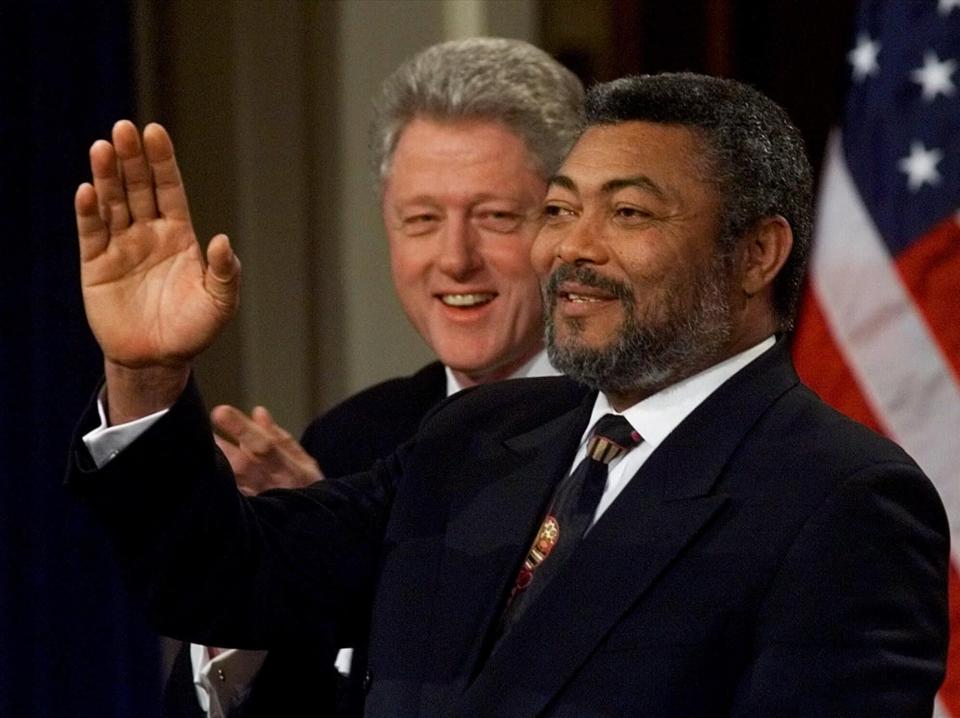 FILE - In this Wednesday, Feb. 24, 1999 file photo, Ghanaian President Jerry Rawlings, right, gestures with President Clinton looking over his shoulder during a news conference at the White House in Washington. Ghana's former president Jerry Rawlings, who staged two coups and later led the West African country's transition to a stable democracy, has died aged 73, according to the state's Radio Ghana and the president Thursday, Nov. 12, 2020. (AP Photo/Doug Mills, File)