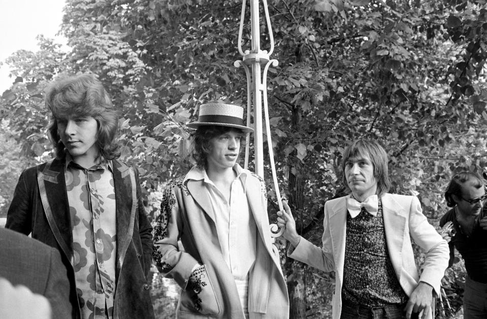 Mick Jagger, center, guitarist Mick Taylor and drummer Charlie Watts, right, of the Rolling Stones speak at a news conference at the Bois de Boulogne in Paris on Sept. 22, 1970.